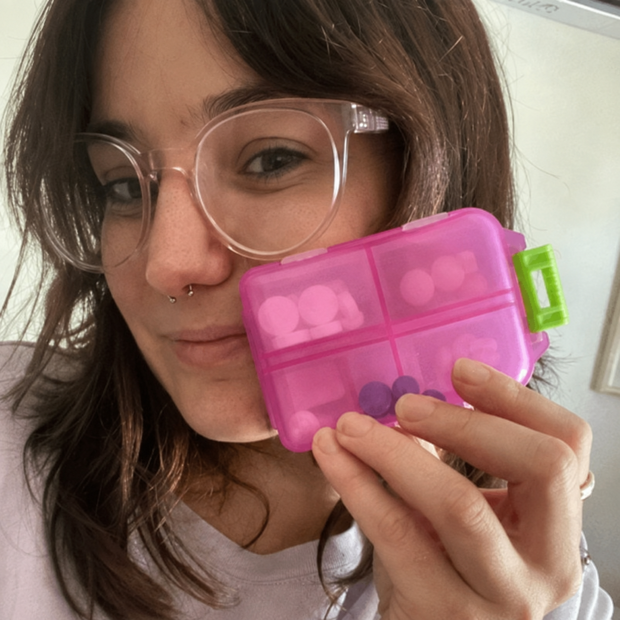 Customer holding pink medication organizer